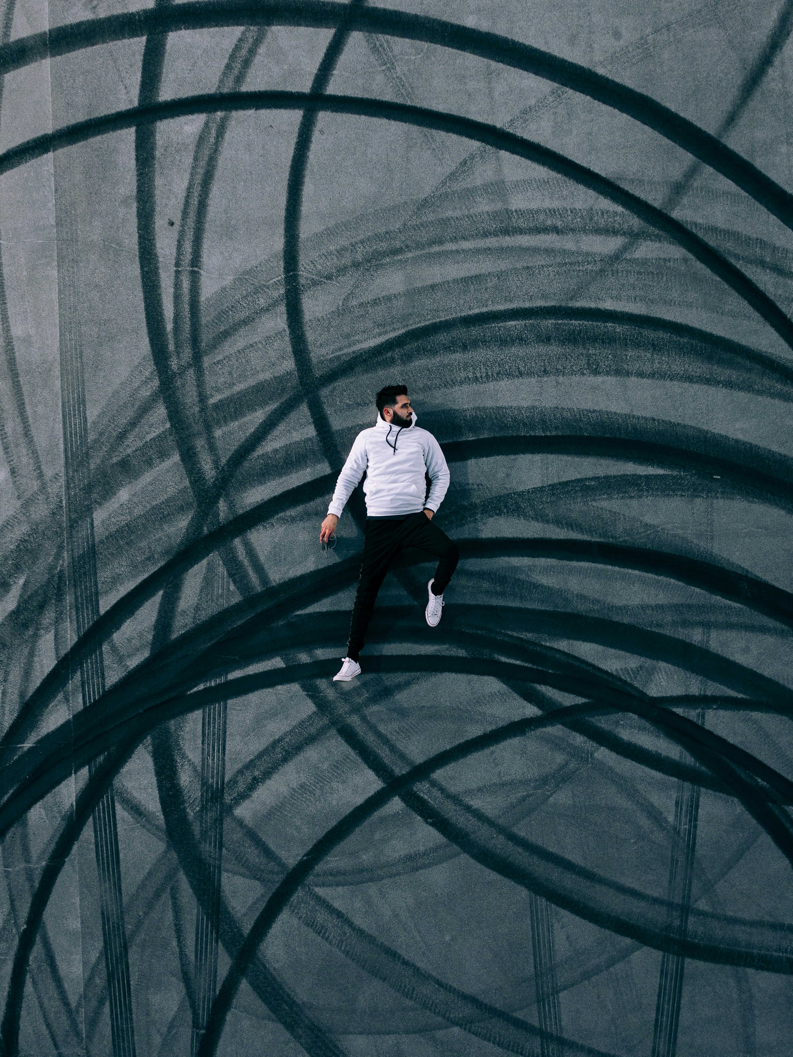 man in white shirt and black pants standing on green tunnel